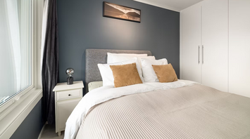 Modern hotel room with soft lighting and neutral decor