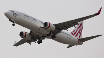 A Virgin Australia airplane taking off with landing gear extended