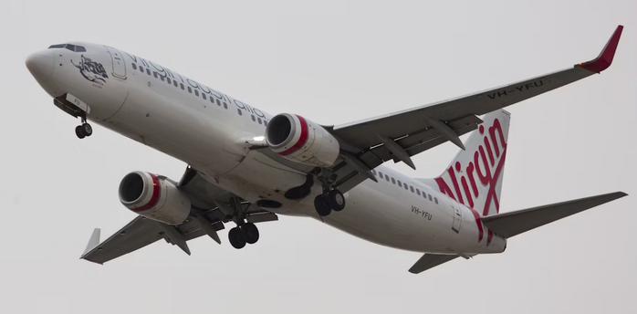A Virgin Australia airplane taking off with landing gear extended