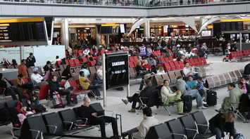 Passengers seated in Terminal 5 at London Heathrow Airport
