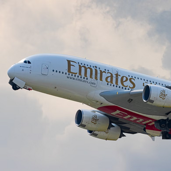 Emirates Airbus A380 taking off under cloudy sky