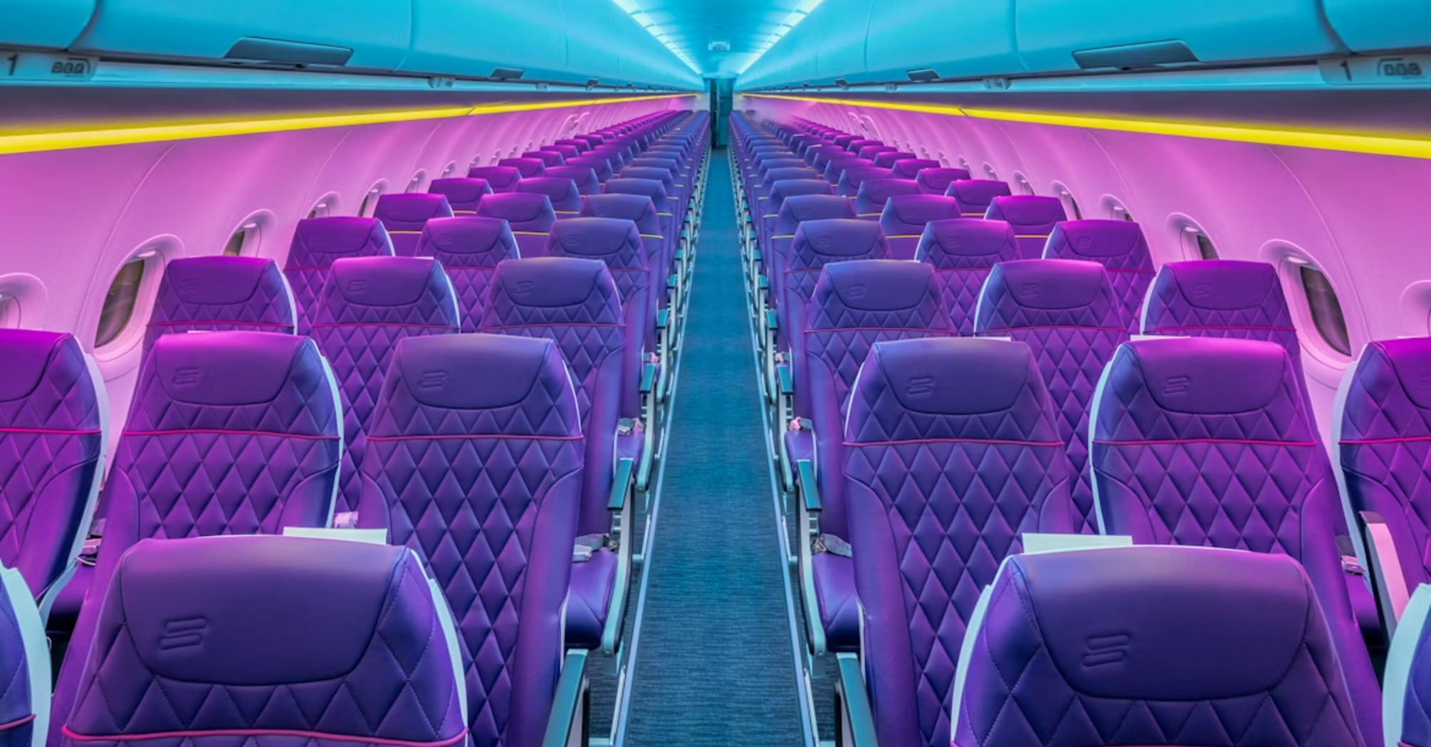 Empty airplane cabin with purple seats and mood lighting