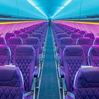 Empty airplane cabin with purple seats and mood lighting