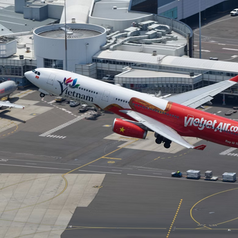 A Vietjet Airbus aircraft taking off from an airport runway during daytime