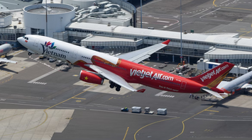 A Vietjet Airbus aircraft taking off from an airport runway during daytime