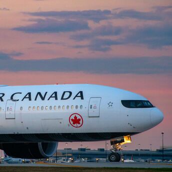 Air Canada aircraft on runway during sunset