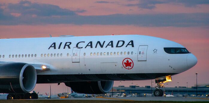 Air Canada aircraft on runway during sunset