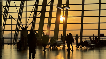 Passengers move through Shanghai Pudong International Airport at sunrise