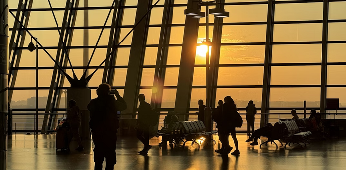 Passengers move through Shanghai Pudong International Airport at sunrise