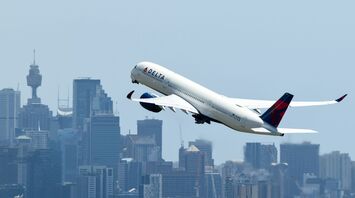 Delta Airbus A350 taking off over city skyline