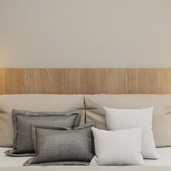 Modern bedroom with wooden headboard, pendant lights, and layered pillows