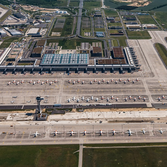 Aerial view of Berlin Brandenburg Airport showing multiple parked Ryanair planes and terminals