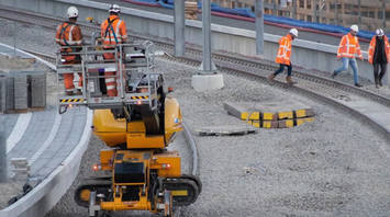 Railway workers performing track maintenance during station upgrade