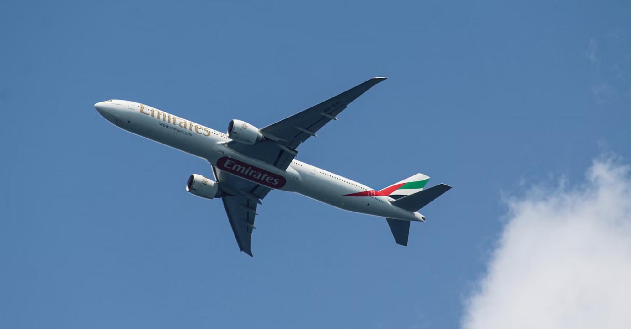 Emirates Boeing 777 aircraft flying in clear sky