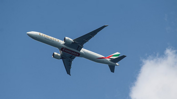 Emirates Boeing 777 aircraft flying in clear sky