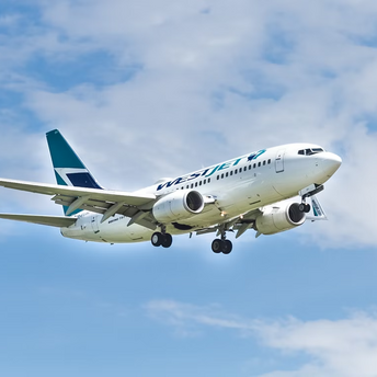 WestJet airplane in flight against a blue sky