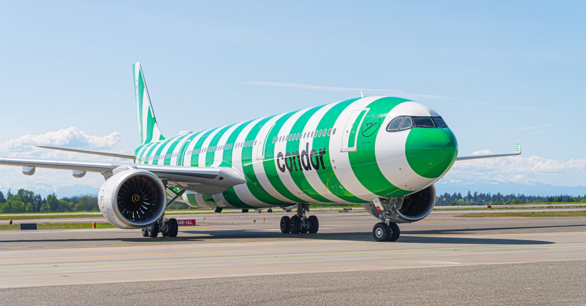 Condor Airbus A330neo with green and white striped livery on airport runway