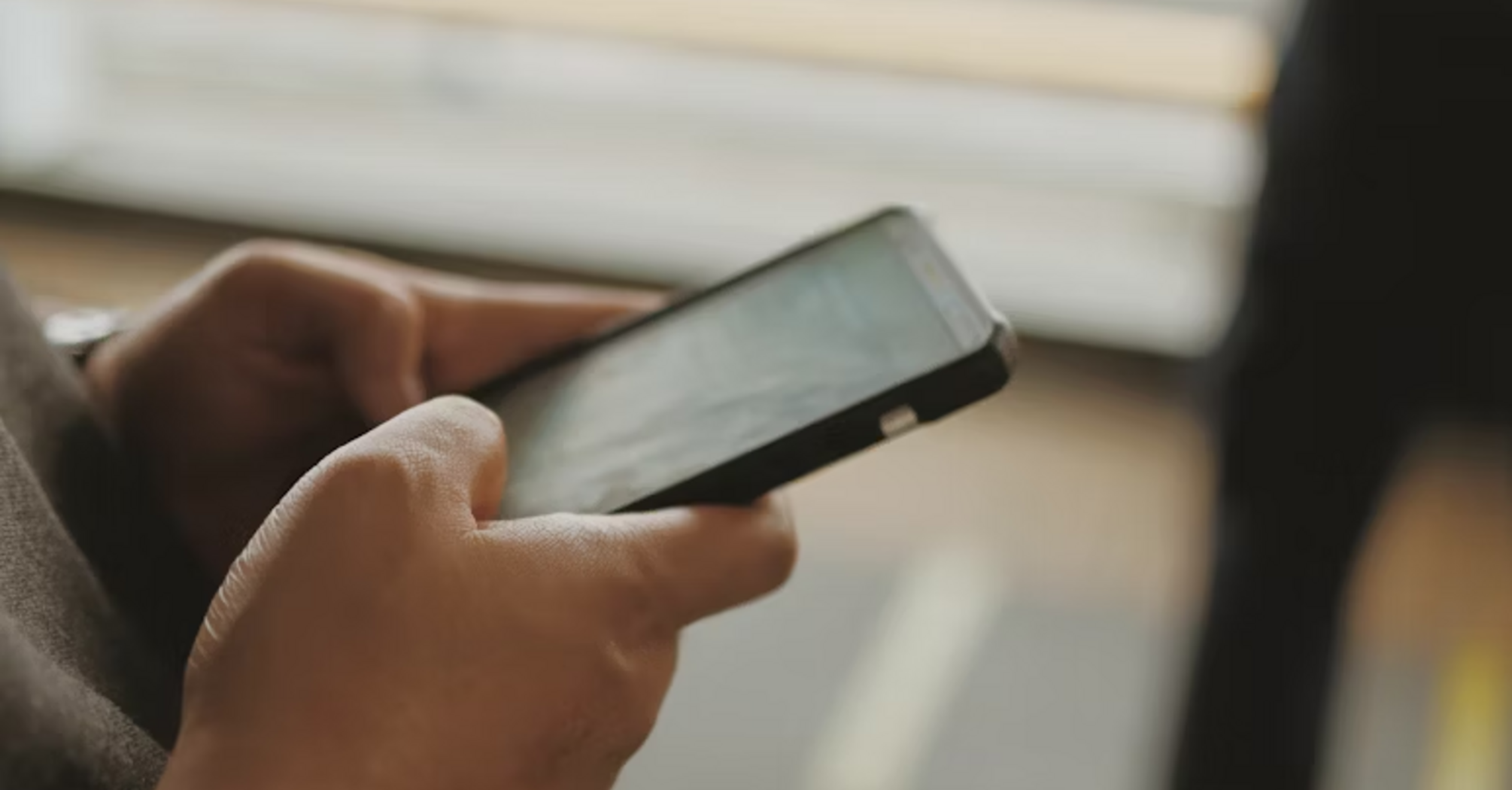 Person using smartphone at airport