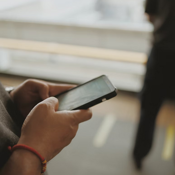 Person using smartphone at airport