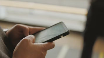 Person using smartphone at airport