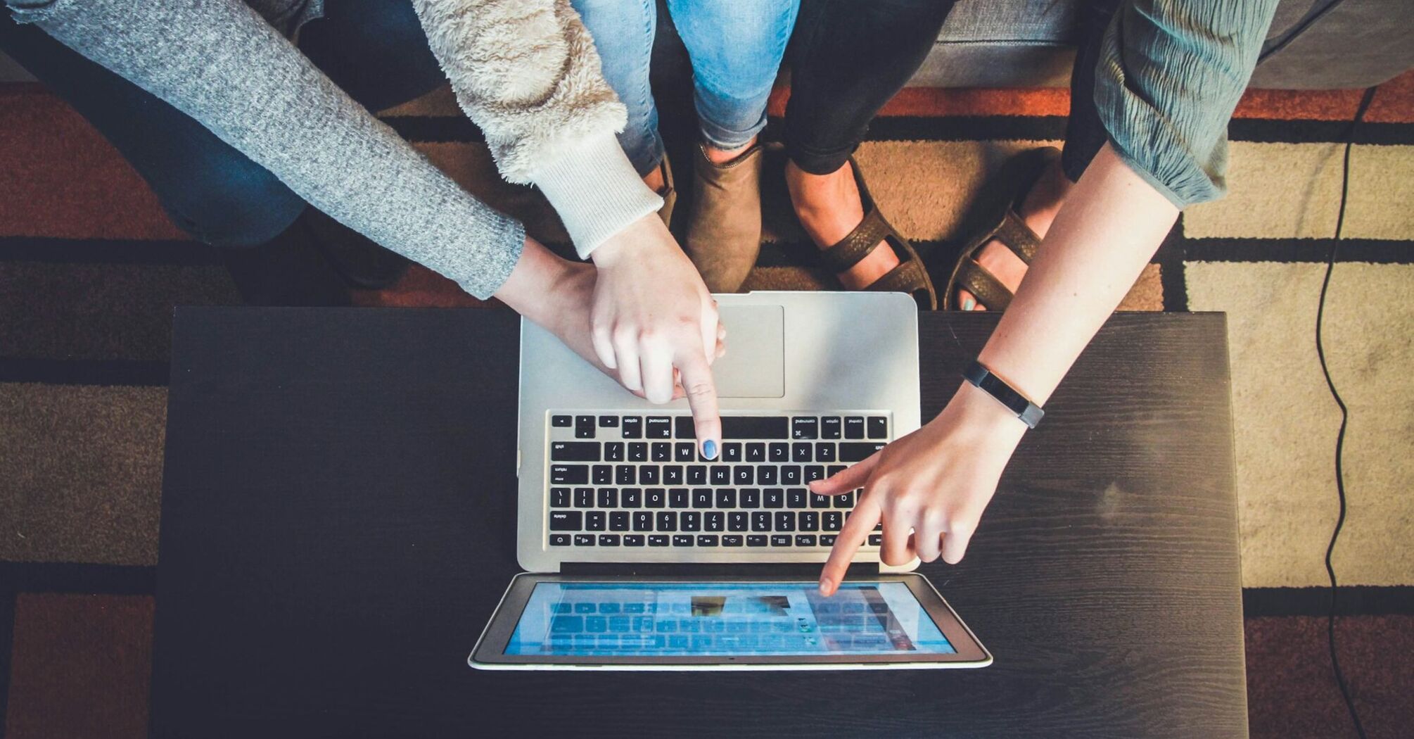 People using a laptop together to book travel online