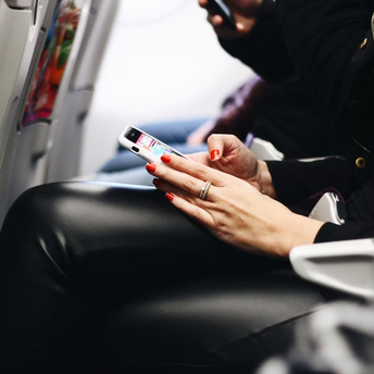 Passenger using smartphone during flight