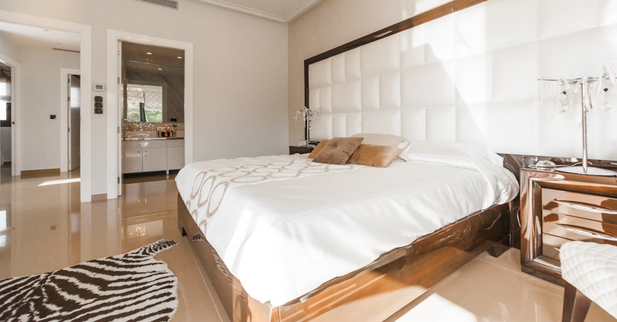 Modern hotel room with large bed and natural light