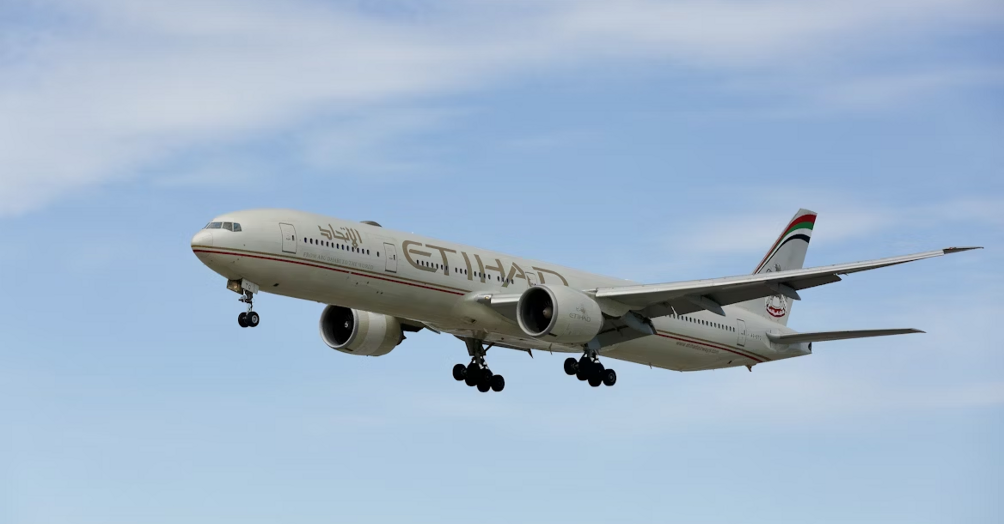 Etihad Airways aircraft approaching for landing against a clear sky