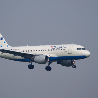 Croatia Airlines aircraft in flight against a clear sky