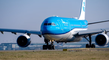 KLM aircraft preparing for takeoff on a clear day