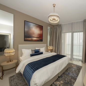 Modern hotel room with neutral tones, large bed, and floor-to-ceiling curtains