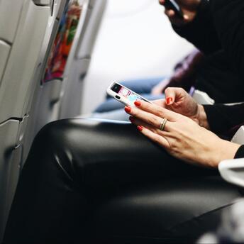 Passenger using phone during a flight