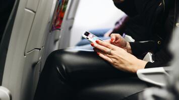 Passenger using phone during a flight