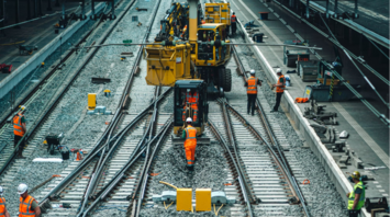 Rail workers performing maintenance on multiple tracks