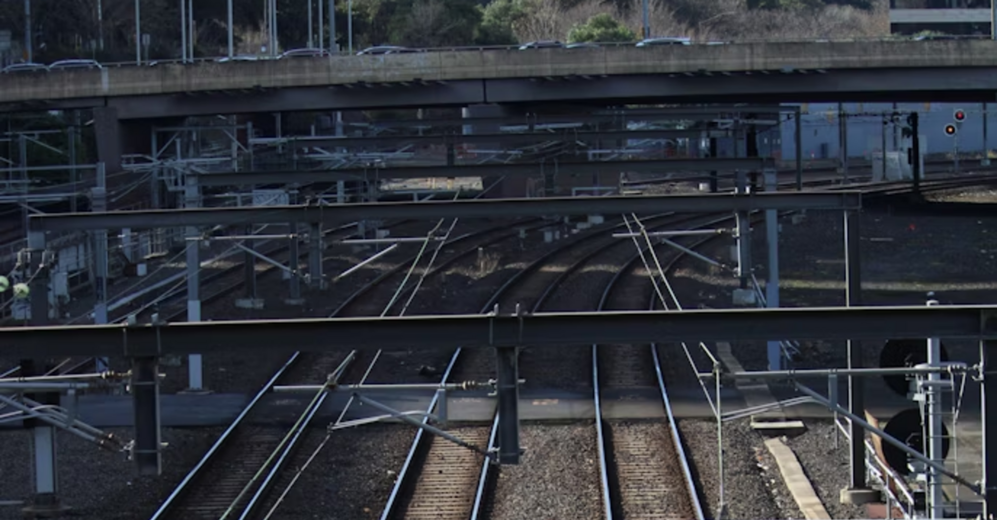 Railway tracks with overhead wires and signalling equipment at a busy junction