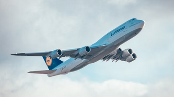 Lufthansa aircraft ascending into cloudy sky