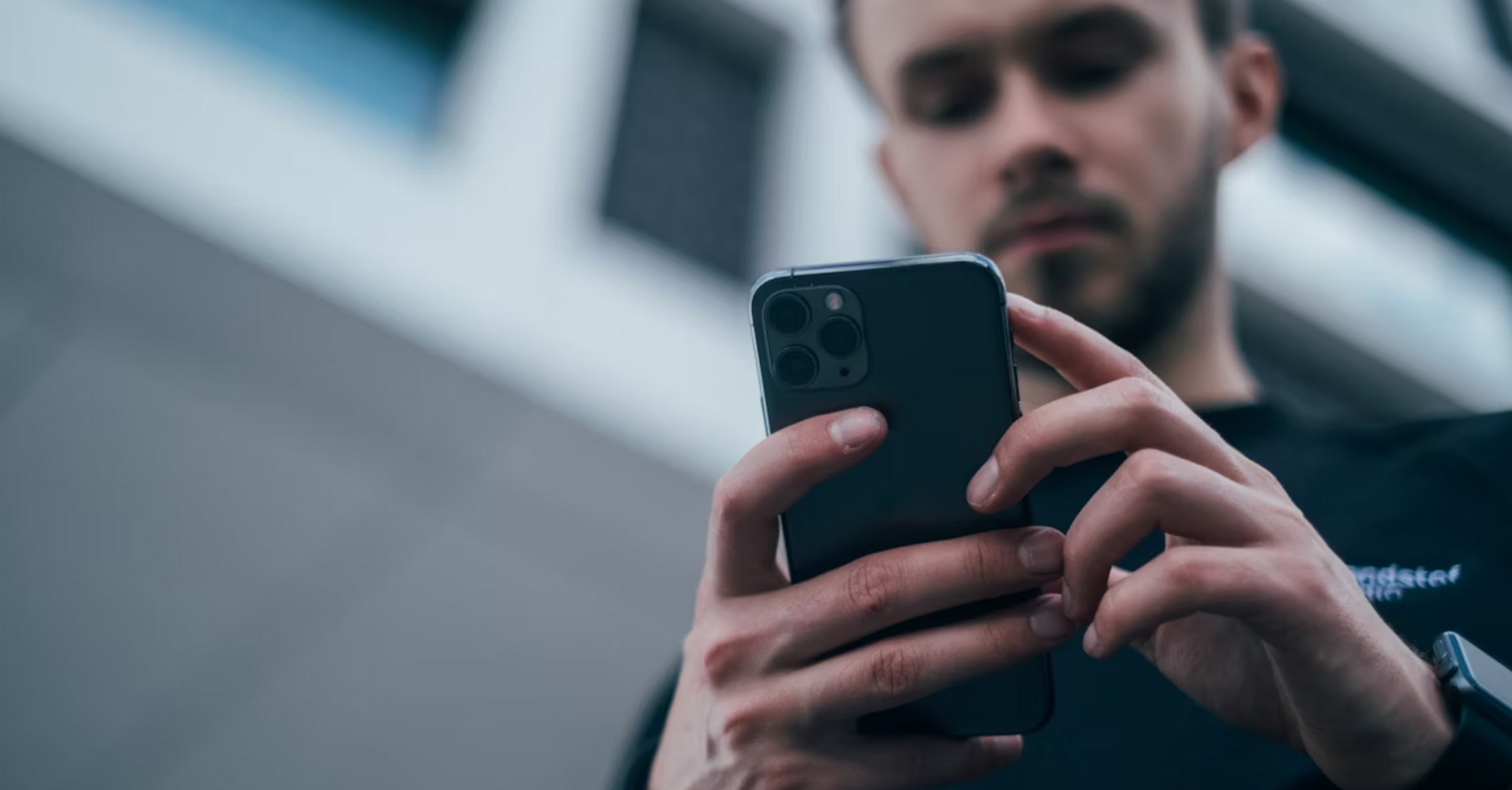Man using smartphone outdoors