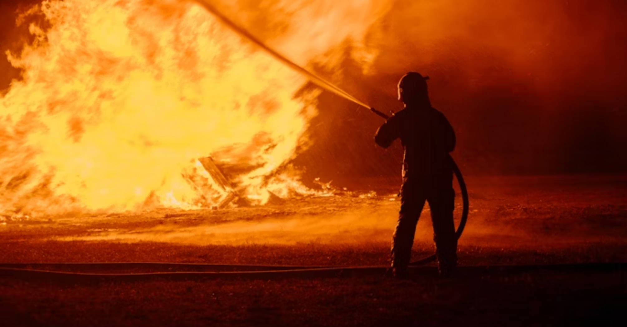 Firefighter tackling a large blaze