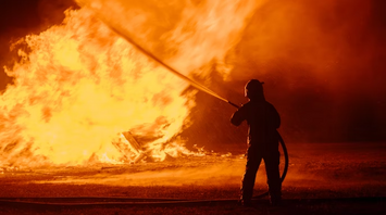 Firefighter tackling a large blaze