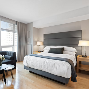 Modern hotel bedroom with sofa and large windows in Kuala Lumpur