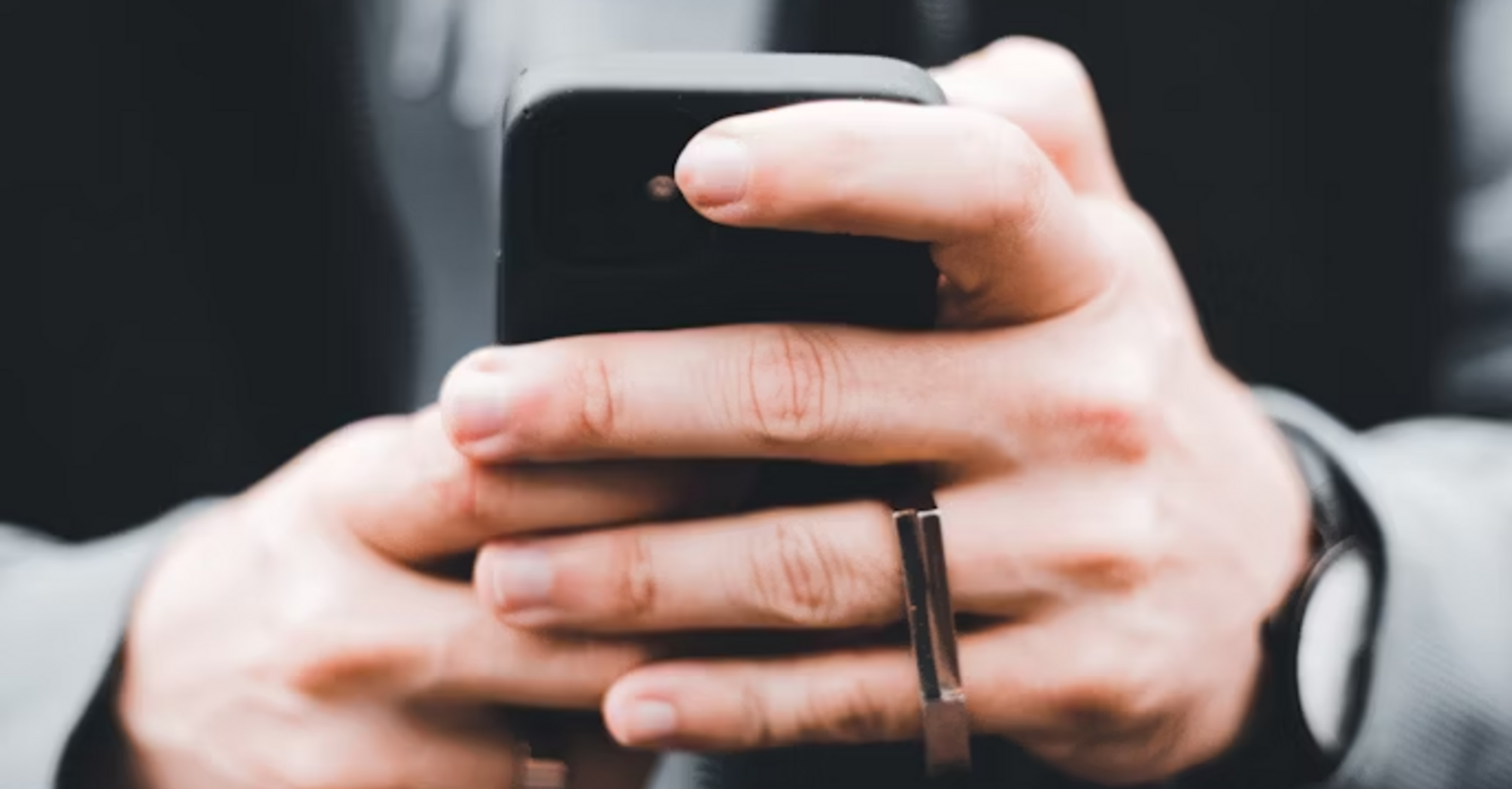 Person holding a smartphone outdoors