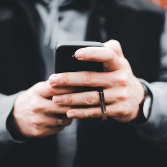 Person holding a smartphone outdoors