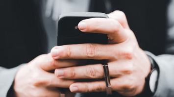 Person holding a smartphone outdoors