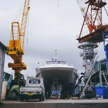 Large ship under construction with cranes