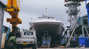 Large ship under construction with cranes