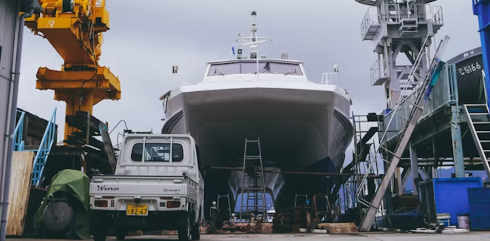 Large ship under construction with cranes