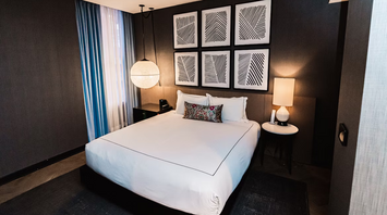 Modern hotel room with minimalist decor and soft lighting