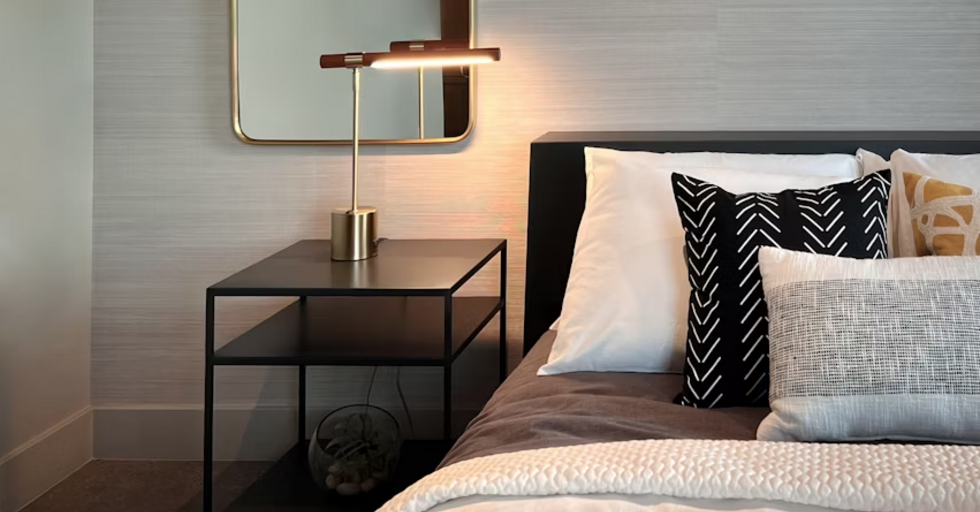 Modern hotel bedroom with bedside table and lamp