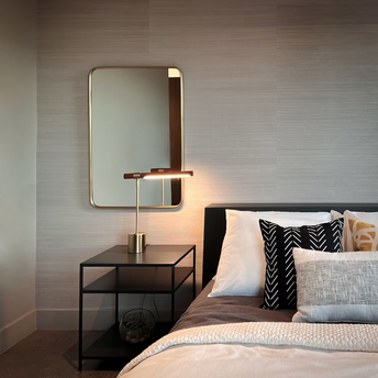 Modern hotel bedroom with bedside table and lamp
