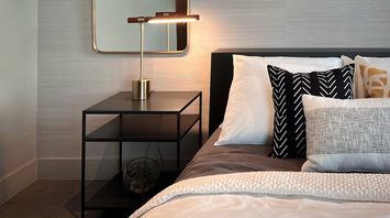 Modern hotel bedroom with bedside table and lamp